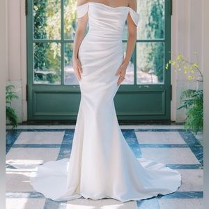 Dramatically draped off the shoulder gown of stretch crepe, buttons to the hem.